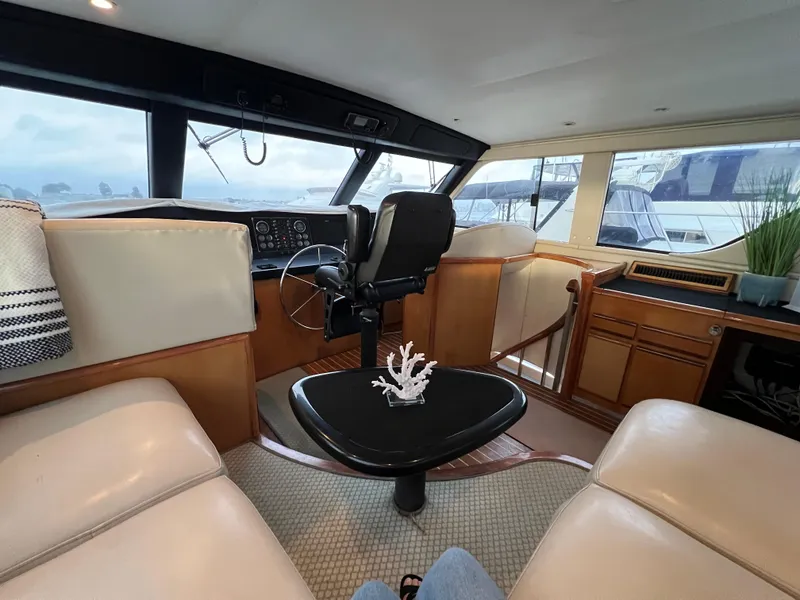 Slide: The Image of Interior of 2000 Viking 58 Enclosed Bridge yacht with helm and seating area. - 29