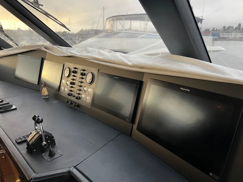 Slide: The Image of Control panel of a 2000 Viking 58 Enclosed Bridge yacht with multiple screens and controls. - 32