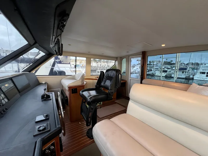 Slide: The Image of Interior of 2000 Viking 58 Enclosed Bridge yacht with helm and seating area. - 35