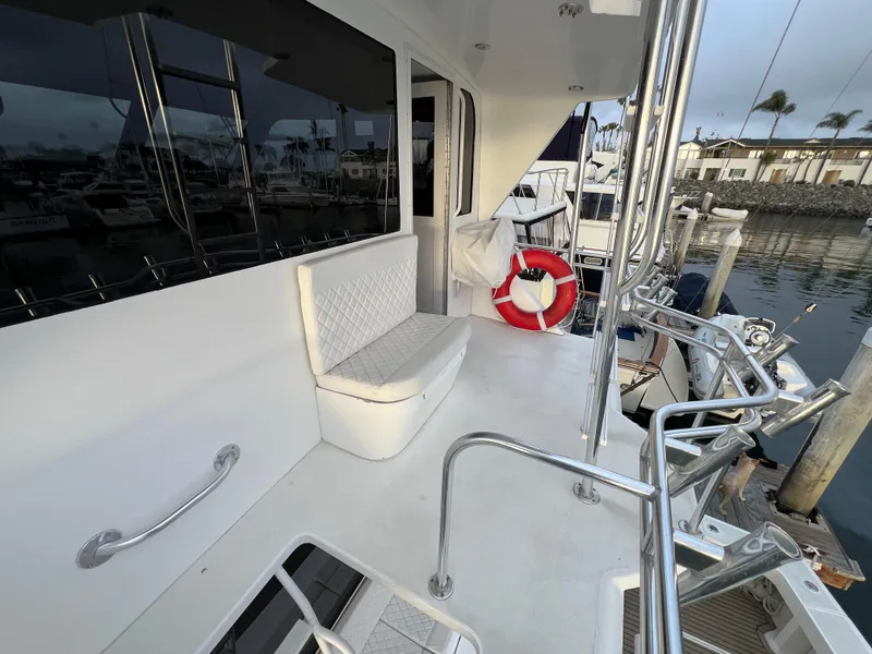 Slide: The Image of Viking 58 Enclosed Bridge 2000 yacht deck with seating and life preserver. - 42