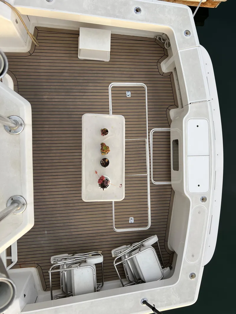 Slide: The Image of Viking 58 Enclosed Bridge 2000 yacht deck with chairs and table, aerial view. - 44