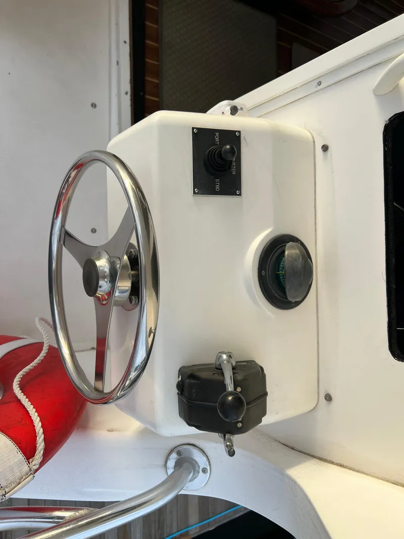 Slide: The Image of Steering wheel and controls of a 2000 Viking 58 Enclosed Bridge yacht. - 45