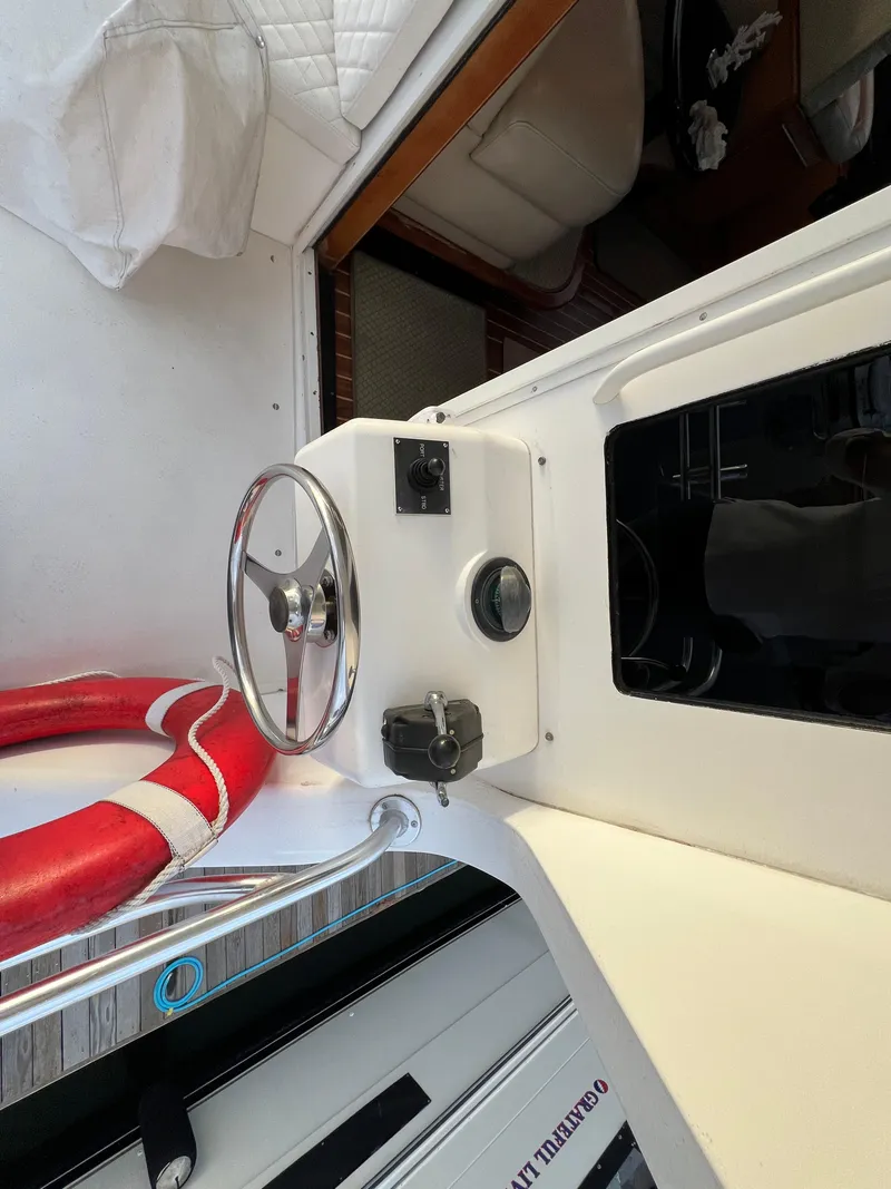 Slide: The Image of Viking 58 Enclosed Bridge 2000 yacht interior with steering wheel and life preserver. - 46