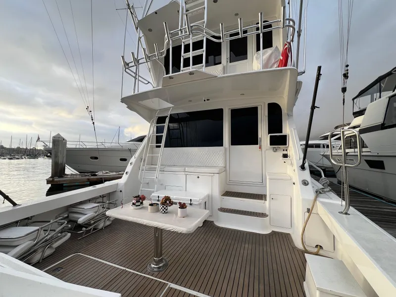 Slide: The Image of 2000 Viking 58 Enclosed Bridge yacht with spacious deck and modern amenities at marina. - 5