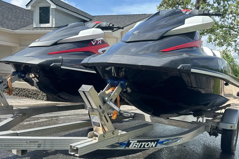 Slide: The Image of 2019 Yamaha WaveRunner VX Cruiser HO jet skis on a Triton trailer, parked outdoors. - 6
