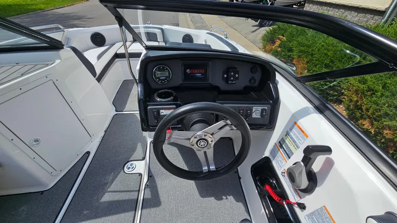 Slide: The Image of 2019 Yamaha AR195 boat cockpit with steering wheel and dashboard controls. - 12