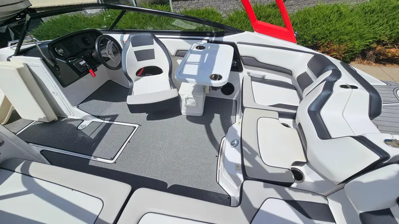Slide: The Image of 2019 Yamaha Boats AR195 interior with seating, steering wheel, and table. - 18