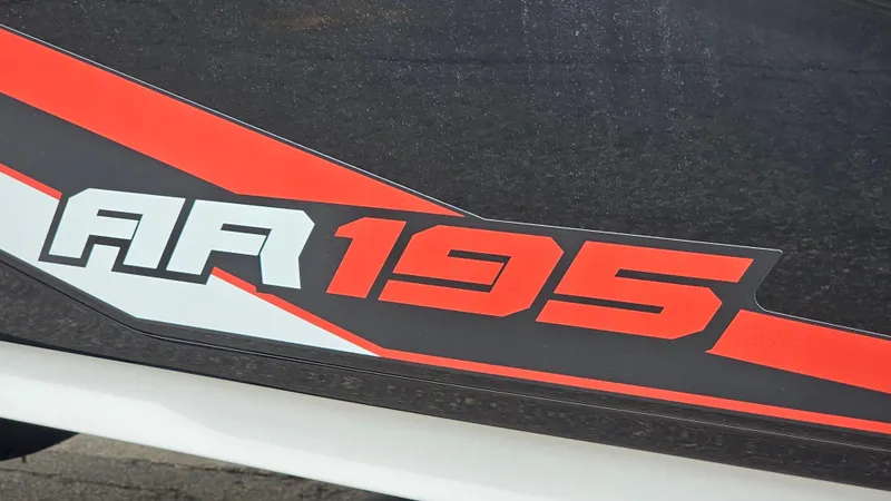 Slide: The Image of 2019 Yamaha Boats AR195 logo with red and white design on dark background. - 23