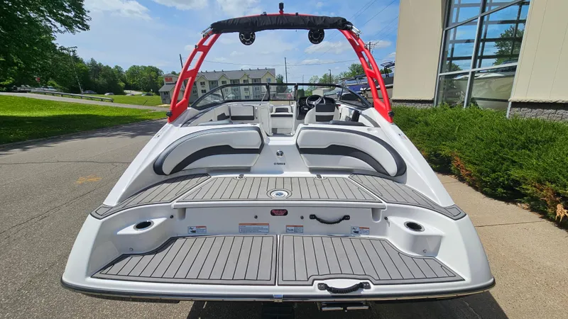 Slide: The Image of 2019 Yamaha Boats AR195 with sleek design and spacious seating, docked outdoors. - 5