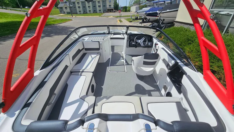 Slide: The Image of 2019 Yamaha AR195 boat interior with seating and steering wheel, featuring red accents. - 6