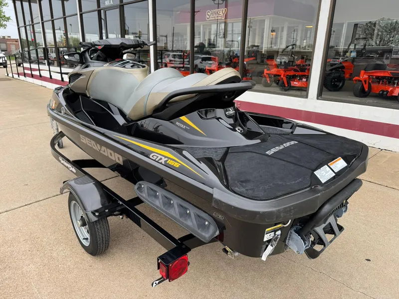 Slide: The Image of 2017 Sea-Doo GTX155 jet ski on trailer, parked outside dealership. - 10