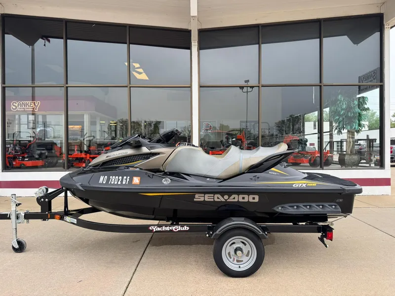 Slide: The Image of 2017 Sea-Doo GTX155 jet ski on trailer, parked outside dealership. - 2