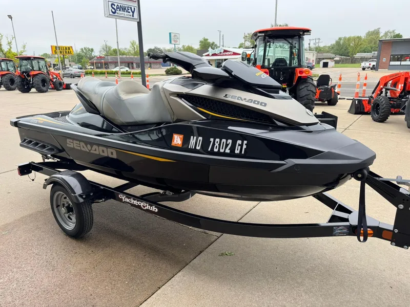 Slide: The Image of 2017 Sea-Doo GTX155 jet ski on trailer, parked outdoors near tractors. - 6