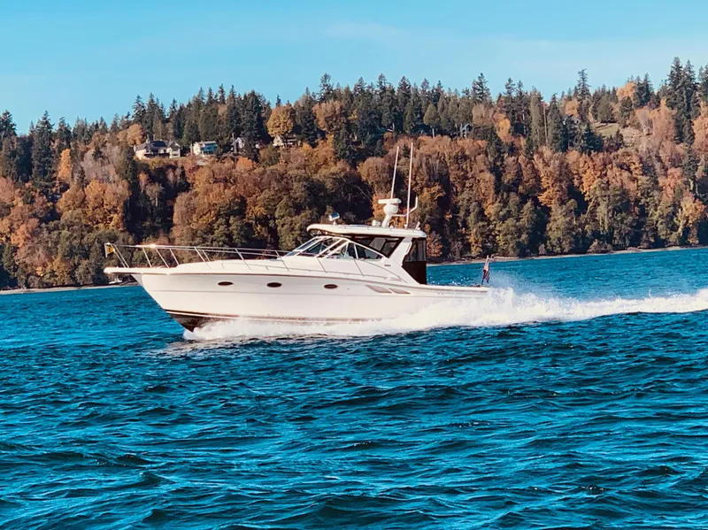 Slide: The Image of 2003 Tiara Yachts 3500 Open cruising on a scenic lake with forested background. - 10