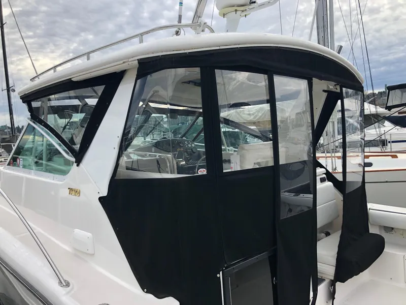 Slide: The Image of 2003 Tiara Yachts 3500 Open with black canvas enclosure at marina. - 13