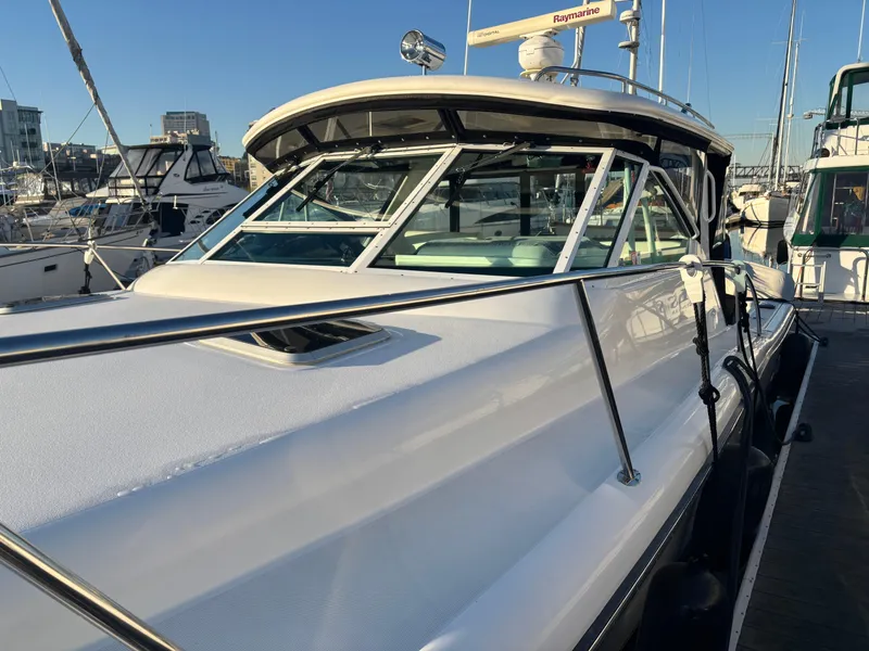 Slide: The Image of 2003 Tiara Yachts 3500 Open docked, showcasing sleek design and spacious deck. - 14