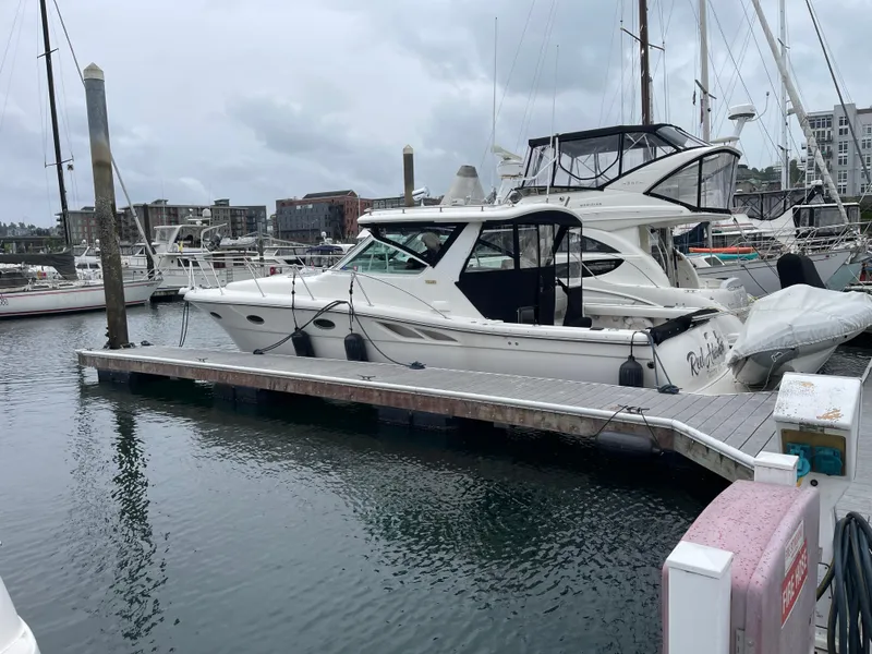 Slide: The Image of 2003 Tiara Yachts 3500 Open docked in a marina, surrounded by other boats. - 16