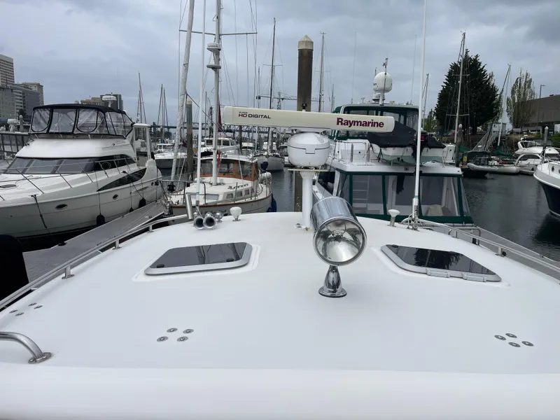 Slide: The Image of 2003 Tiara Yachts 3500 Open docked in a marina, surrounded by other boats. - 17