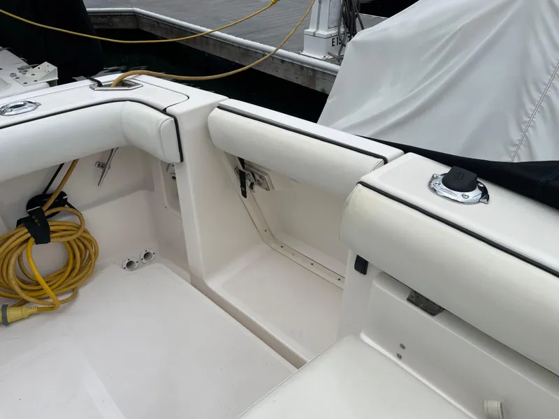 Slide: The Image of 2003 Tiara Yachts 3500 Open interior with white seating and docked at marina. - 19