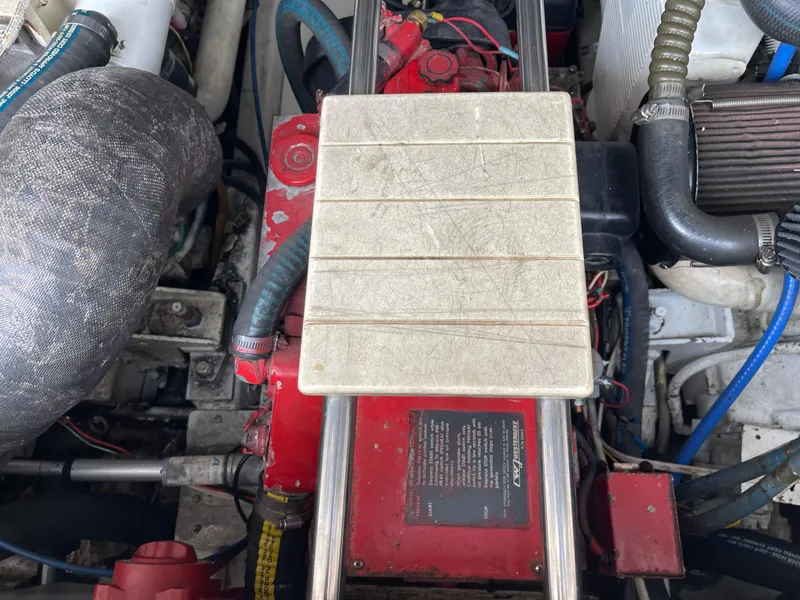 Slide: The Image of Engine compartment of a 2003 Tiara Yachts 3500 Open, showcasing mechanical components and wiring. - 21