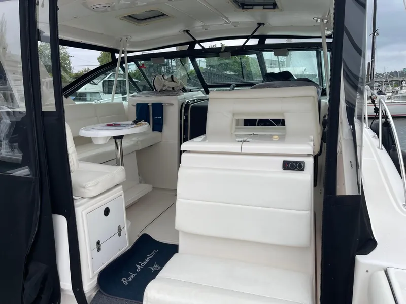 Slide: The Image of 2003 Tiara Yachts 3500 Open interior with white seating and helm station. - 23