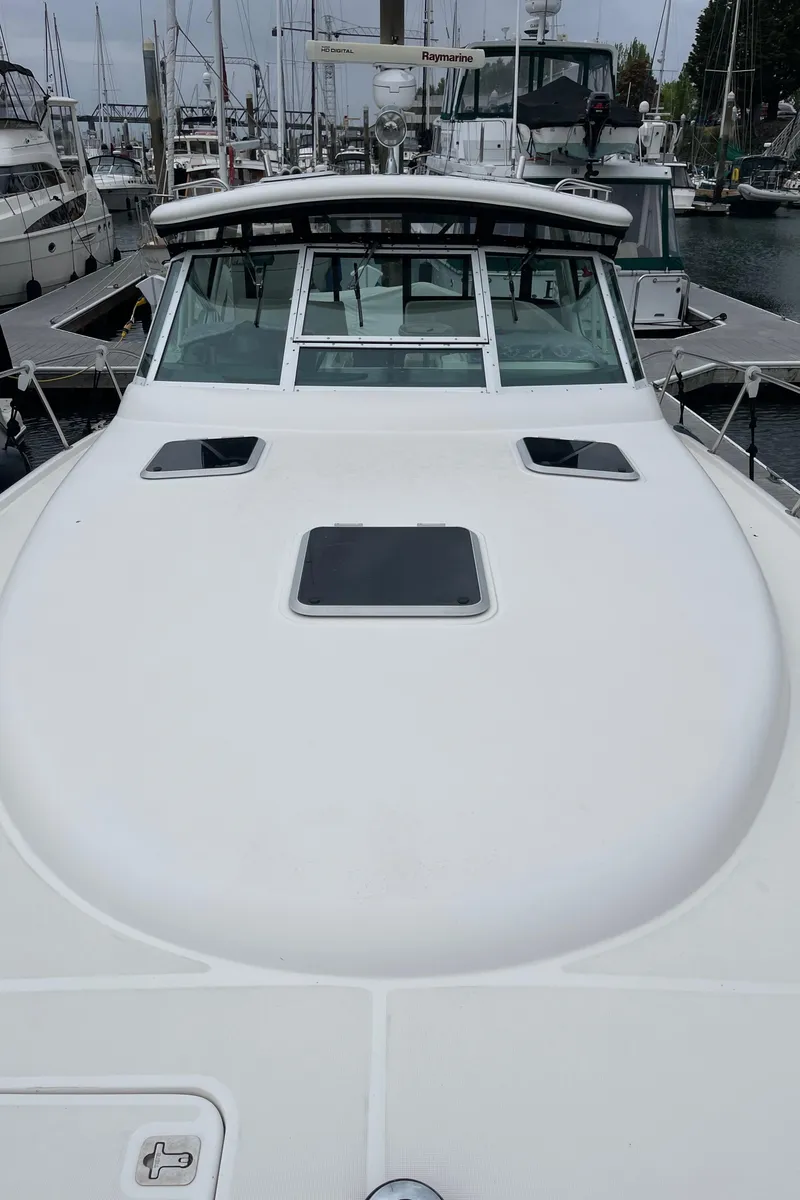 Slide: The Image of 2003 Tiara Yachts 3500 Open docked at a marina, showcasing sleek design and spacious deck. - 27
