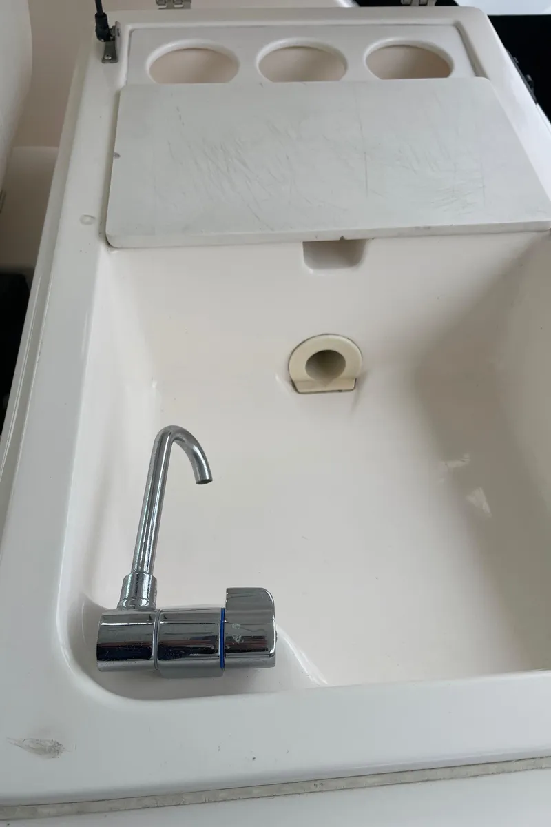 Slide: The Image of 2003 Tiara Yachts 3500 Open sink with chrome faucet and cutting board. - 29