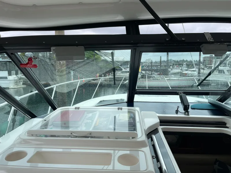Slide: The Image of Interior view of 2003 Tiara Yachts 3500 Open, showcasing helm and marina backdrop. - 30