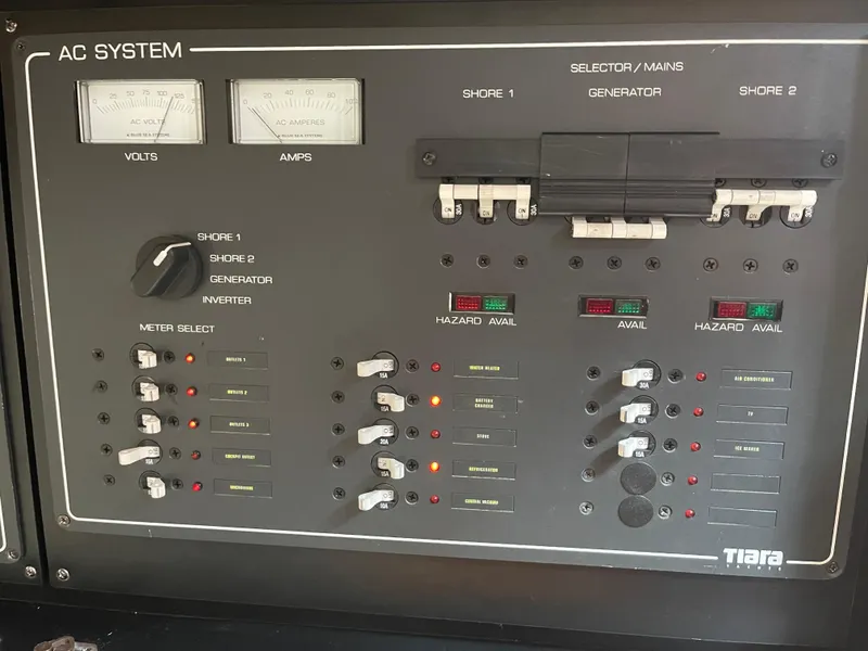 Slide: The Image of 2003 Tiara Yachts 3500 Open AC system control panel with volt and amp meters. - 38