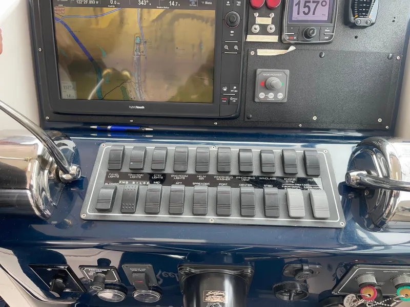 Slide: The Image of Control panel of a 2003 Tiara Yachts 3500 Open with navigation display and switches. - 40
