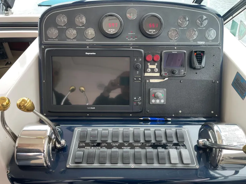 Slide: The Image of Control panel of a 2003 Tiara Yachts 3500 Open with navigation and engine controls. - 44
