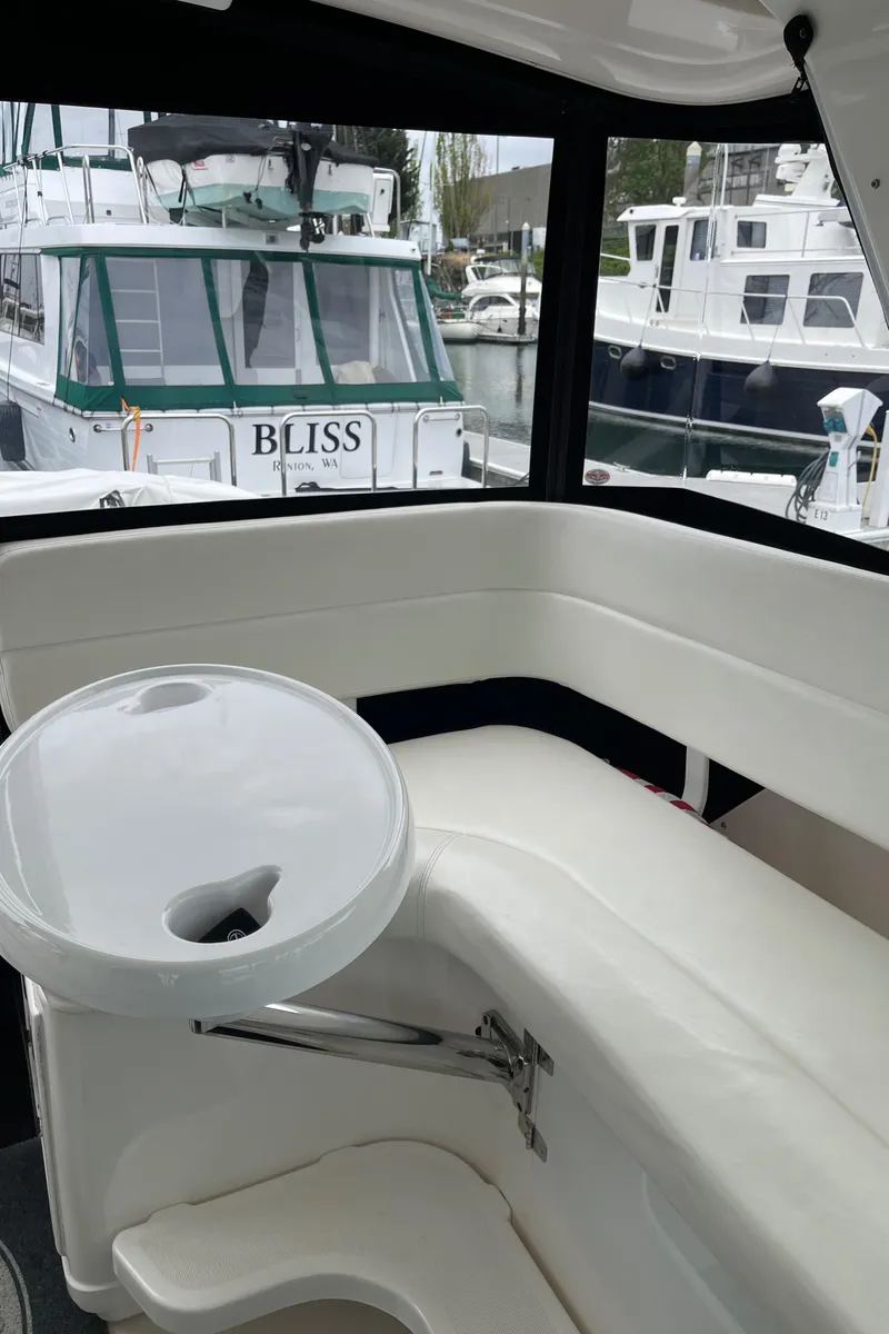Slide: The Image of 2003 Tiara Yachts 3500 Open interior with seating and table, docked at marina. - 46