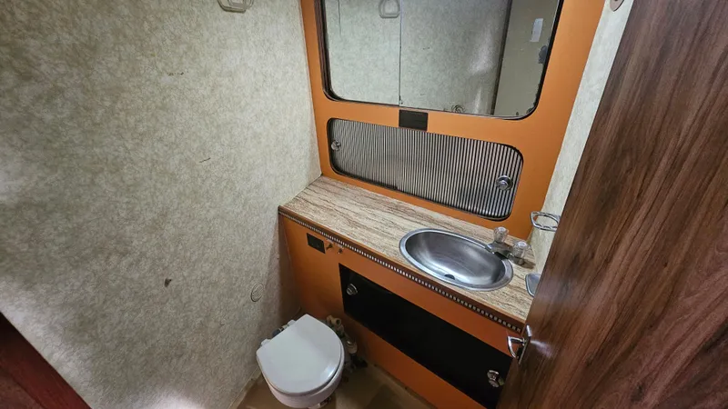 Slide: The Image of 1982 Chris-Craft 381 Catalina bathroom with sink, mirror, and toilet. - 13