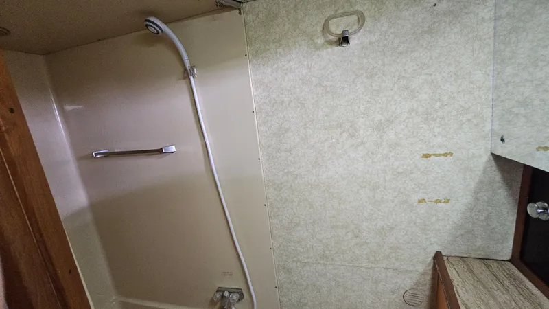Slide: The Image of 1982 Chris-Craft 381 Catalina bathroom with shower and beige walls. - 19