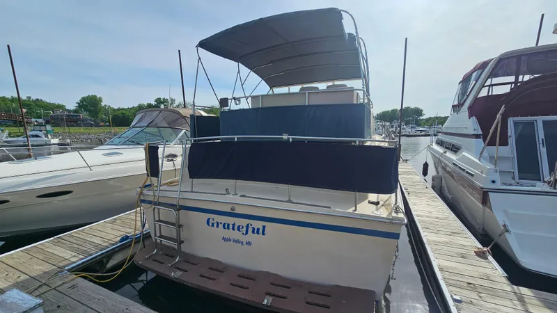 Slide: The Image of 1982 Chris-Craft 381 Catalina docked, rear view with canopy and ladder. - 3