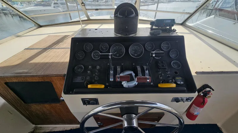 Slide: The Image of 1982 Chris-Craft 381 Catalina helm with gauges, steering wheel, and fire extinguisher. - 7