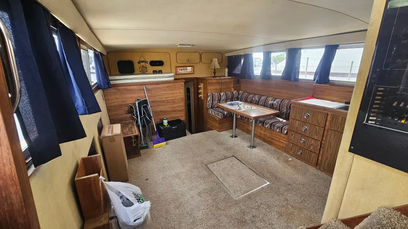 Slide: The Image of Interior of 1982 Chris-Craft 381 Catalina yacht with cozy seating and wood paneling. - 8