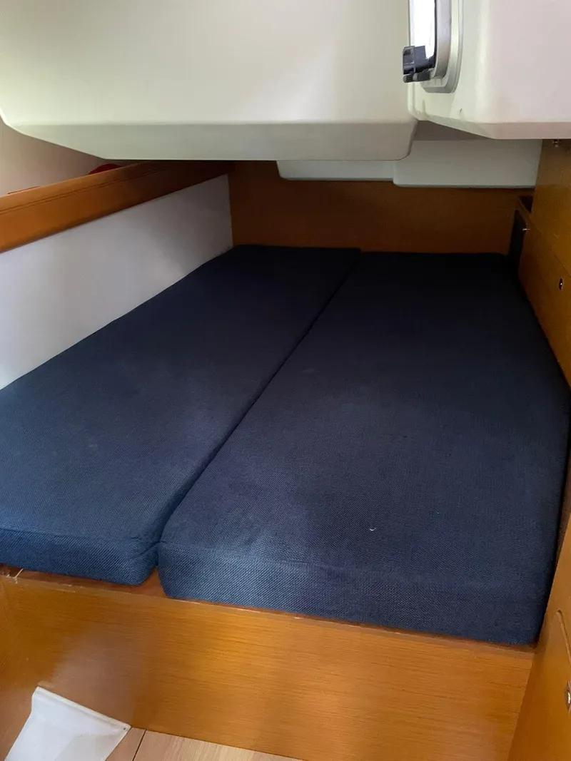 Slide: The Image of Interior cabin of 2017 Jeanneau Sun Odyssey 479 sailboat with dark cushions. - 29