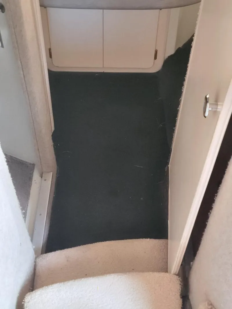 Slide: The Image of Interior view of 1989 Bluewater Yachts Coastal Cruiser 42, featuring carpeted flooring and storage cabinets. - 11