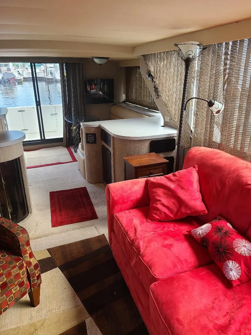 Slide: The Image of Interior of 1989 Bluewater Yachts Coastal Cruiser 42 with red sofa and modern decor. - 12