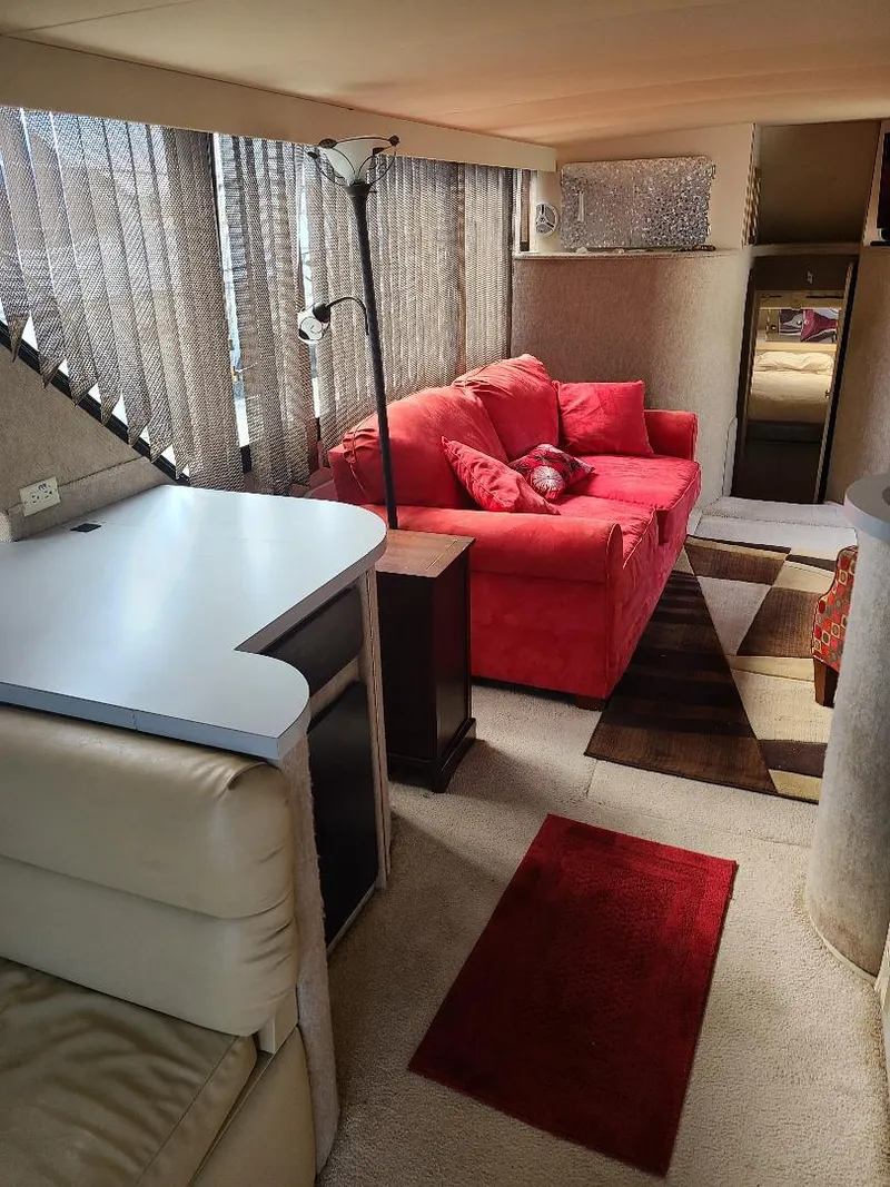 Slide: The Image of Interior of 1989 Bluewater Yachts Coastal Cruiser 42 with red sofa and modern decor. - 15