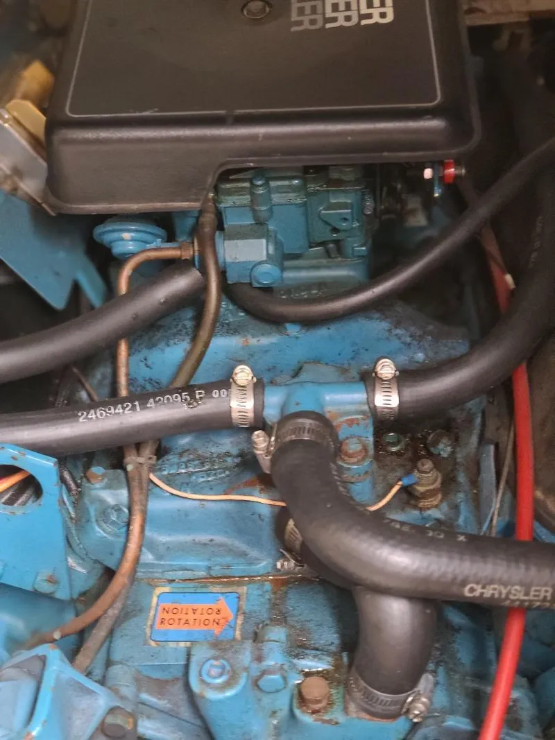 Slide: The Image of Engine compartment of a 1989 Bluewater Yachts Coastal Cruiser 42, featuring hoses and components. - 16