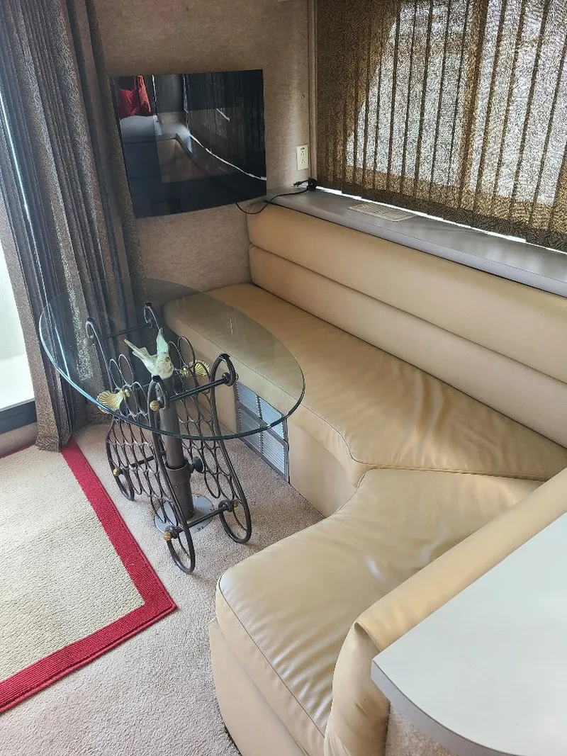 Slide: The Image of Interior of 1989 Bluewater Yachts Coastal Cruiser 42 with leather seating and glass table. - 18