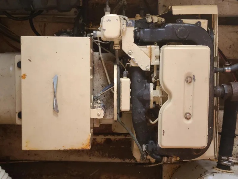 Slide: The Image of Engine compartment of a 1989 Bluewater Yachts Coastal Cruiser 42, showing mechanical components. - 20