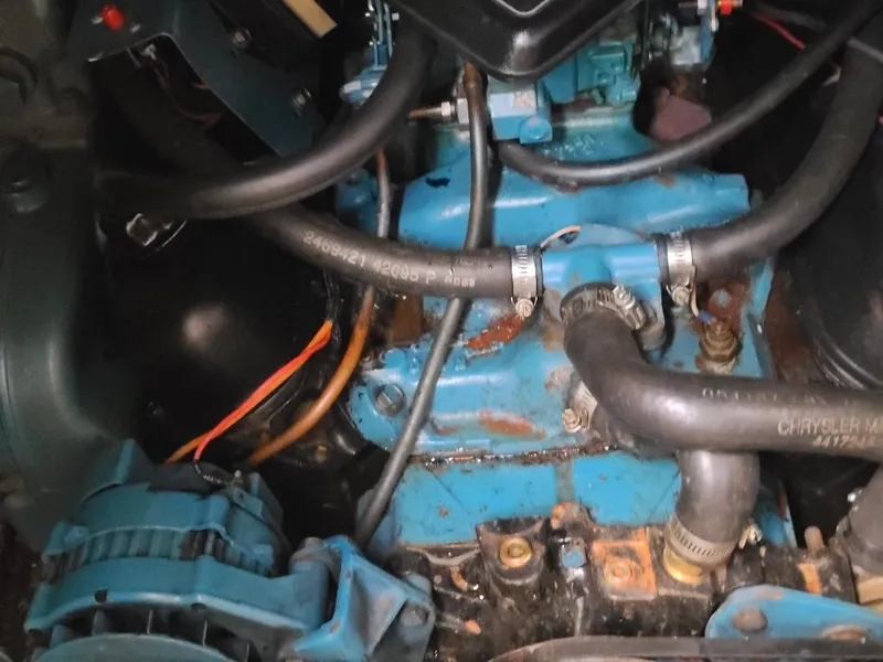 Slide: The Image of Engine compartment of a 1989 Bluewater Yachts Coastal Cruiser 42, featuring hoses and components. - 22