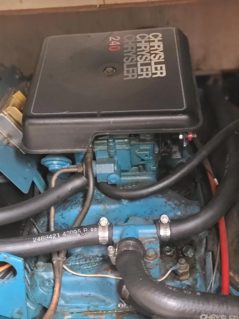 Slide: The Image of Chrysler 240 engine in 1989 Bluewater Yachts Coastal Cruiser 42, featuring hoses and components. - 23