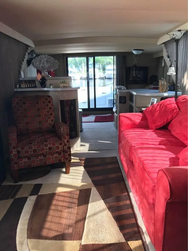 Slide: The Image of Interior of 1989 Bluewater Yachts Coastal Cruiser 42 with red sofa and patterned armchair. - 3