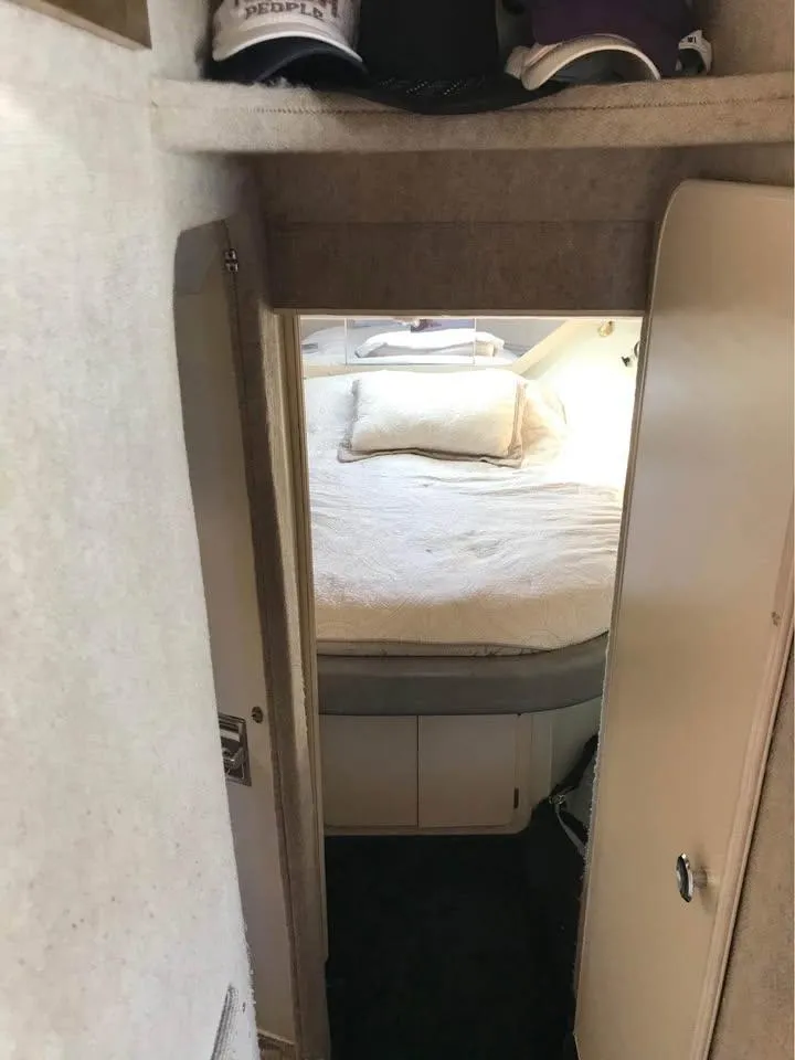 Slide: The Image of 1989 Bluewater Yachts Coastal Cruiser 42 interior cabin with bed and storage. - 4