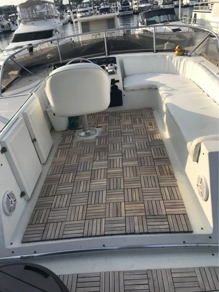 Slide: The Image of 1989 Bluewater Yachts Coastal Cruiser 42 with spacious deck and seating at marina. - 8