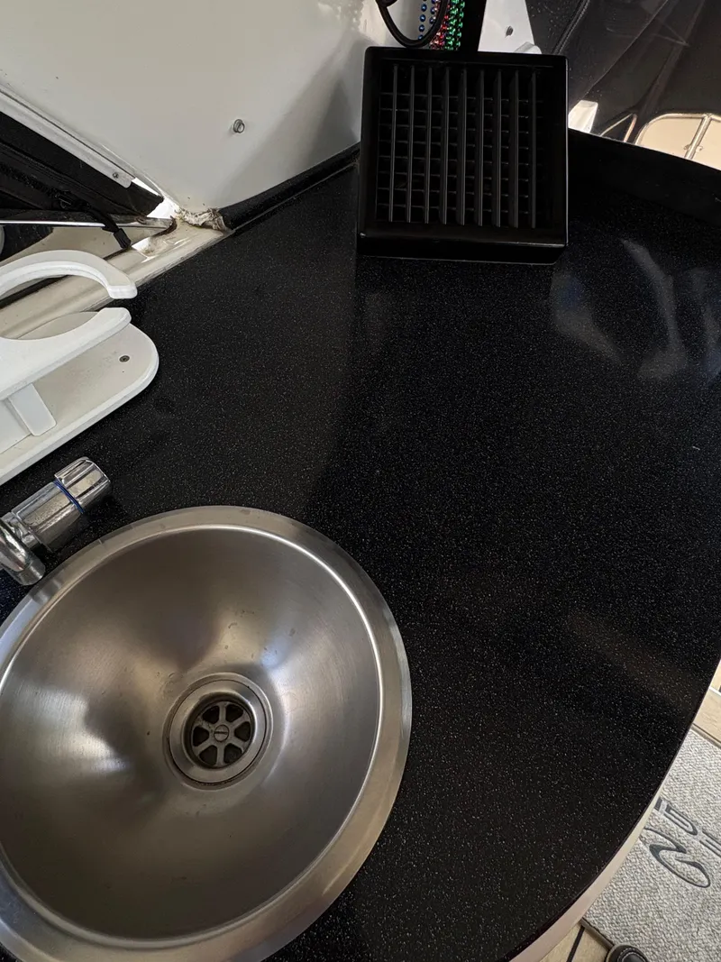 Slide: The Image of Stainless steel sink on 2003 Regal 4260 Express Cruiser's sleek black countertop. - 11